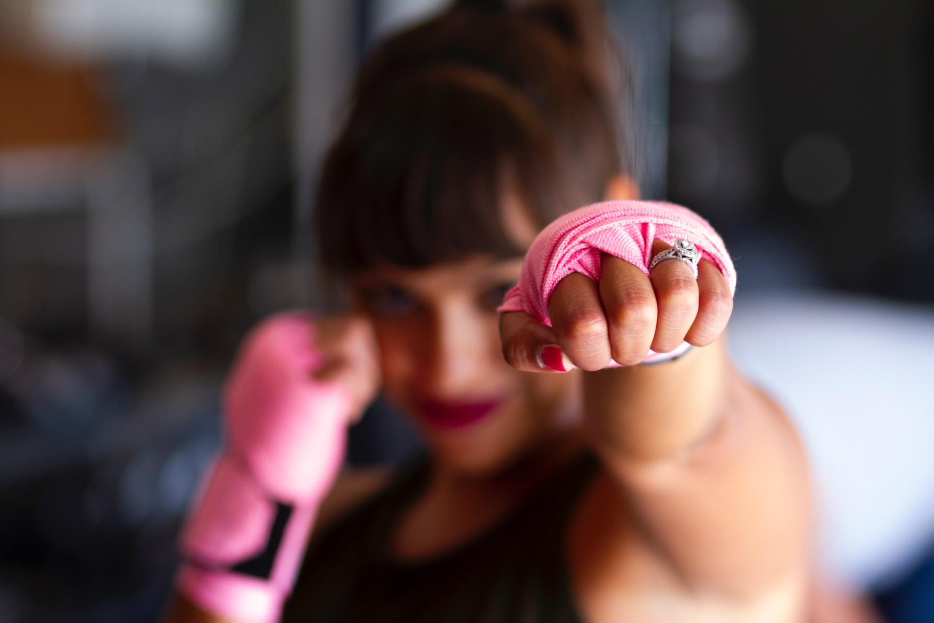Woman punching air with hands tied for boxing gloves